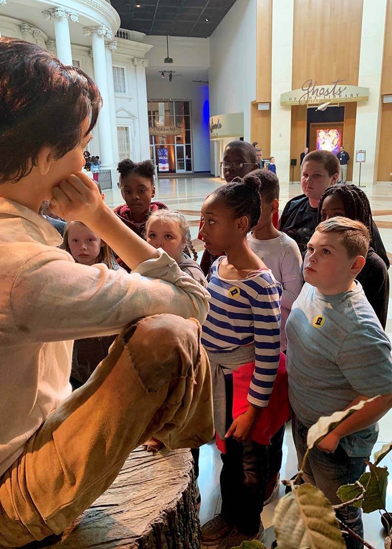 Students gathered around young Lincoln